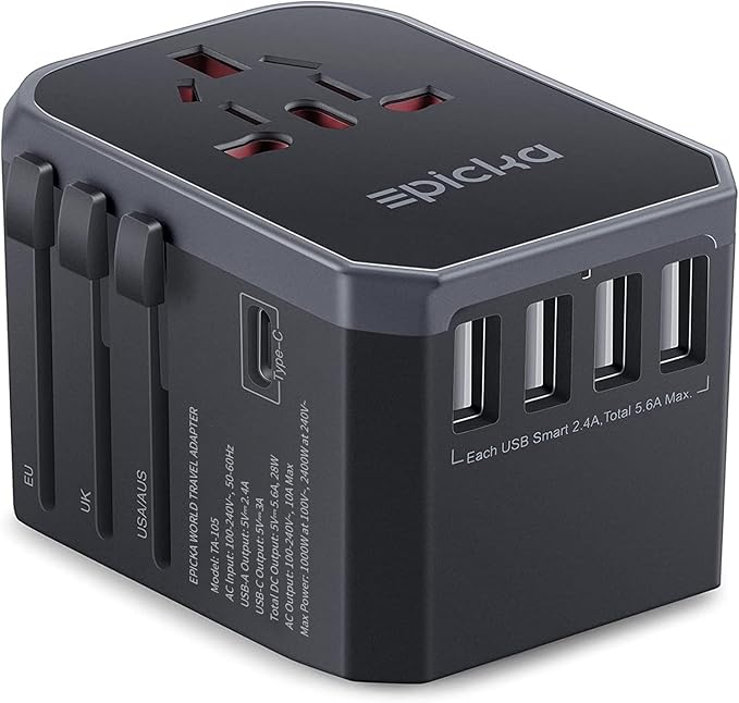 Universal travel adapter with USB-C ports plugged into a European wall outlet